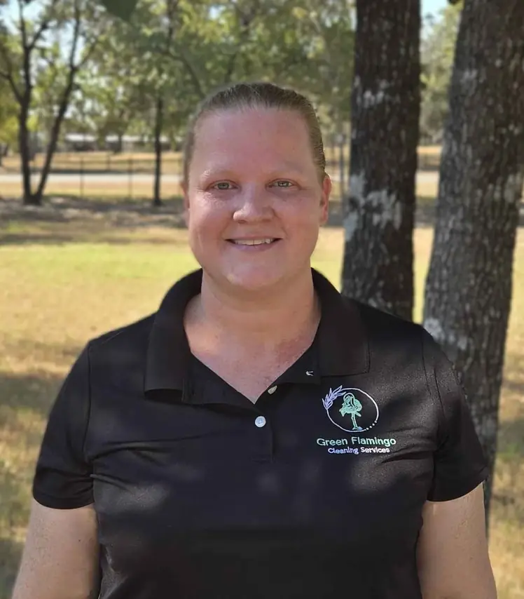 Courtney C in the black Green Flamingo polo, standing outdoors