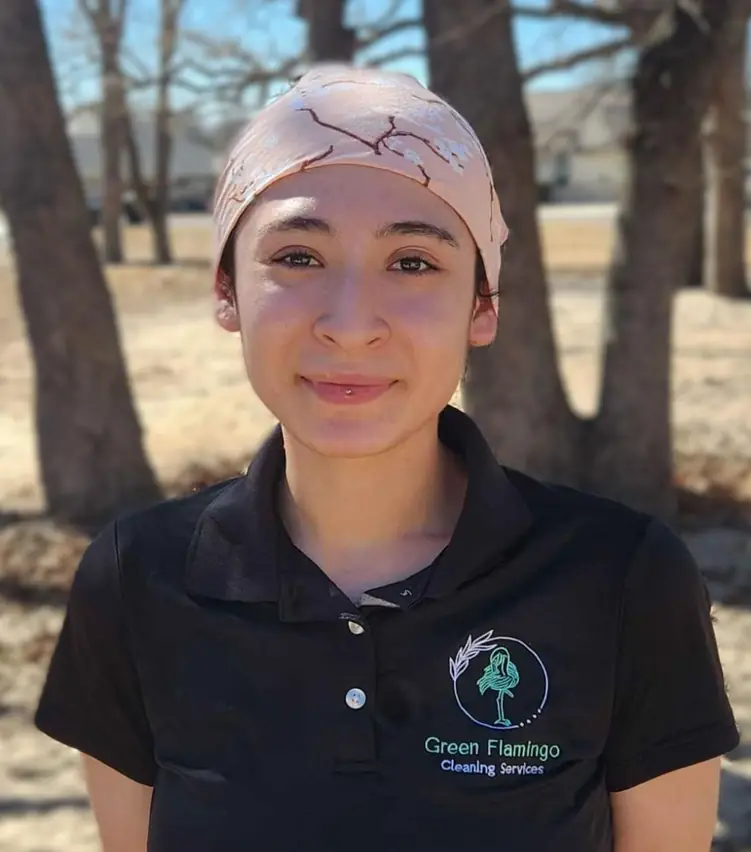 Lexy L in the black Green Flamingo polo, standing outdoors