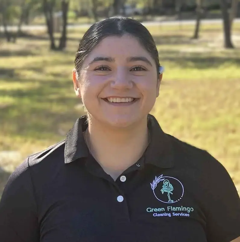 Natalia E in the black Green Flamingo polo, standing outdoors