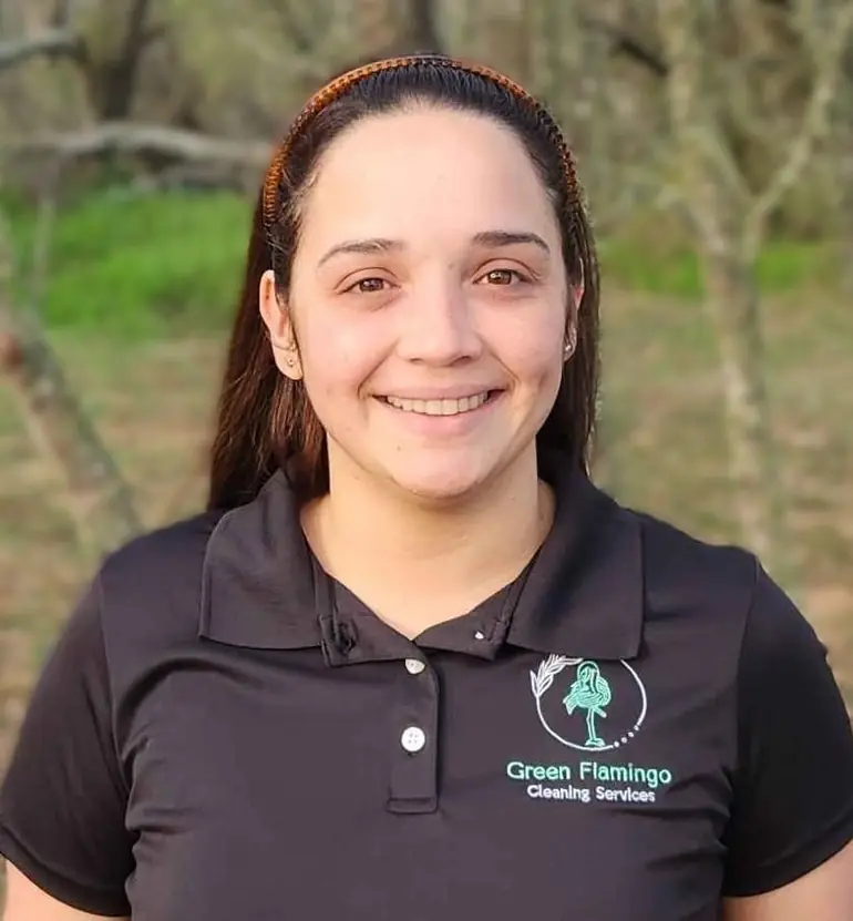 Wilnelia S in the black Green Flamingo polo, standing outdoors