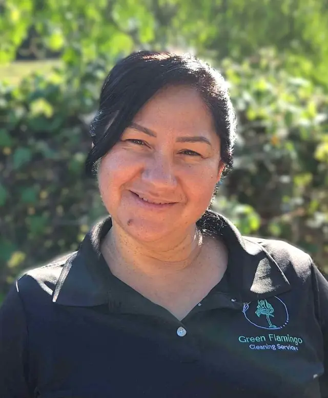 Yolanda G in the black Green Flamingo polo, standing outdoors
